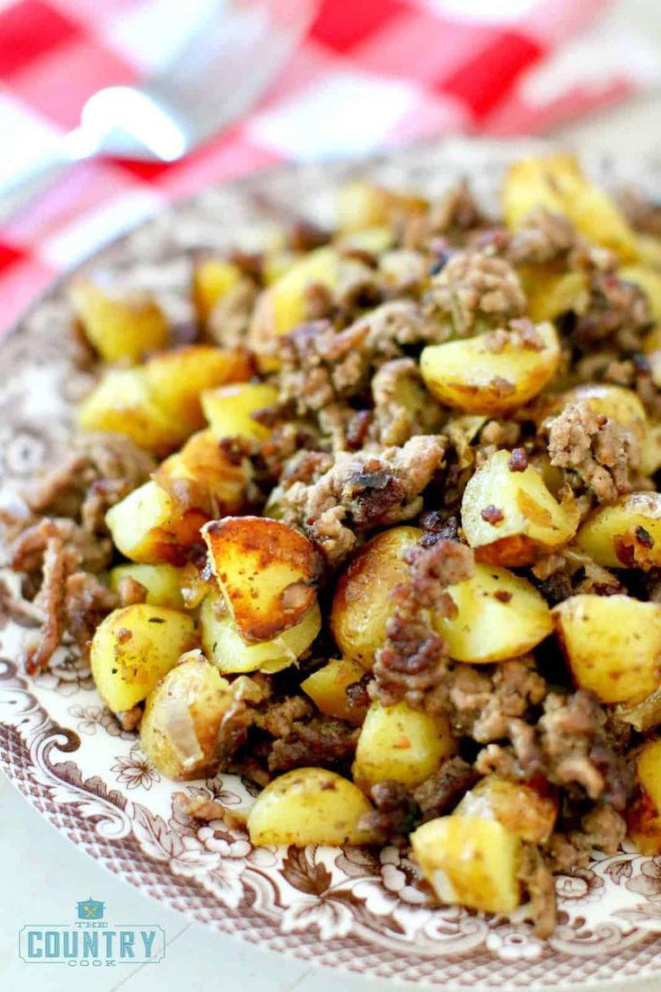 a close up of a plate of food on a table with a checkered cloth