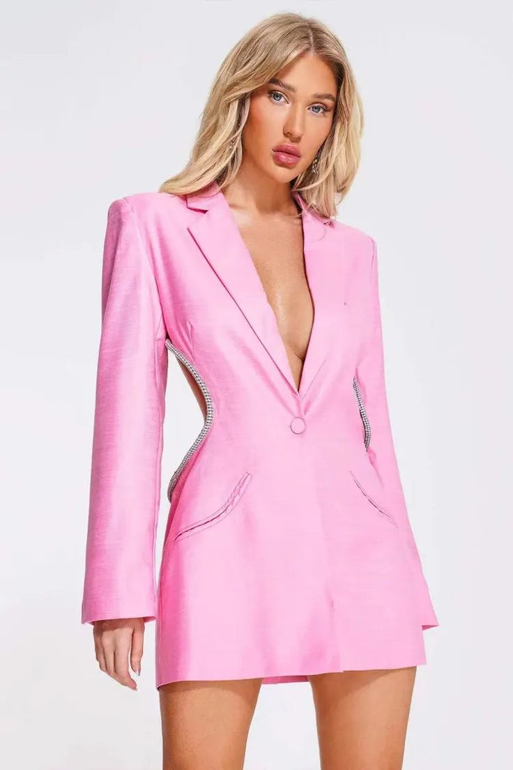 a woman wearing a pink blazer and shorts