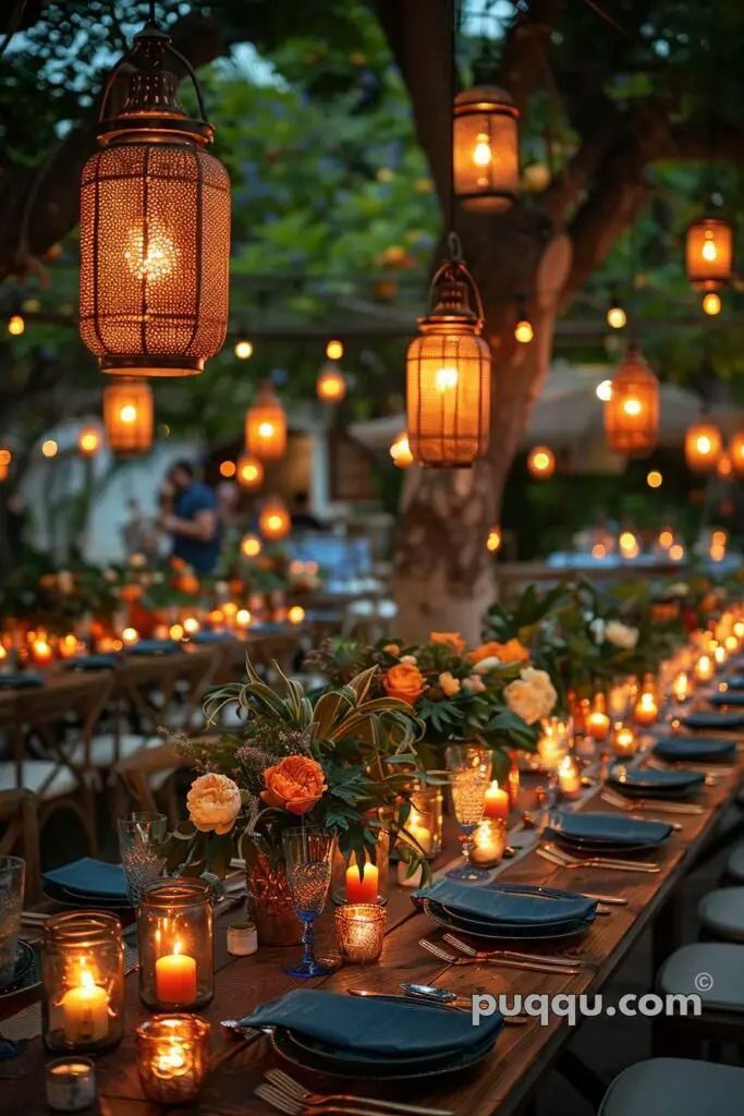 a long table is set with candles and plates for an outdoor dinner or party in the evening