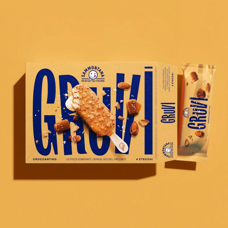 an open box of grani bar next to it's wrapper on a yellow background