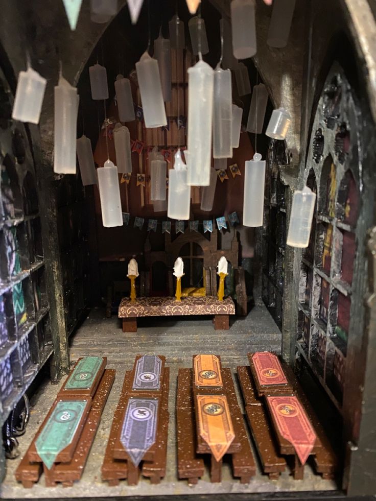 the inside of an old church with stained glass windows and wooden pews on display