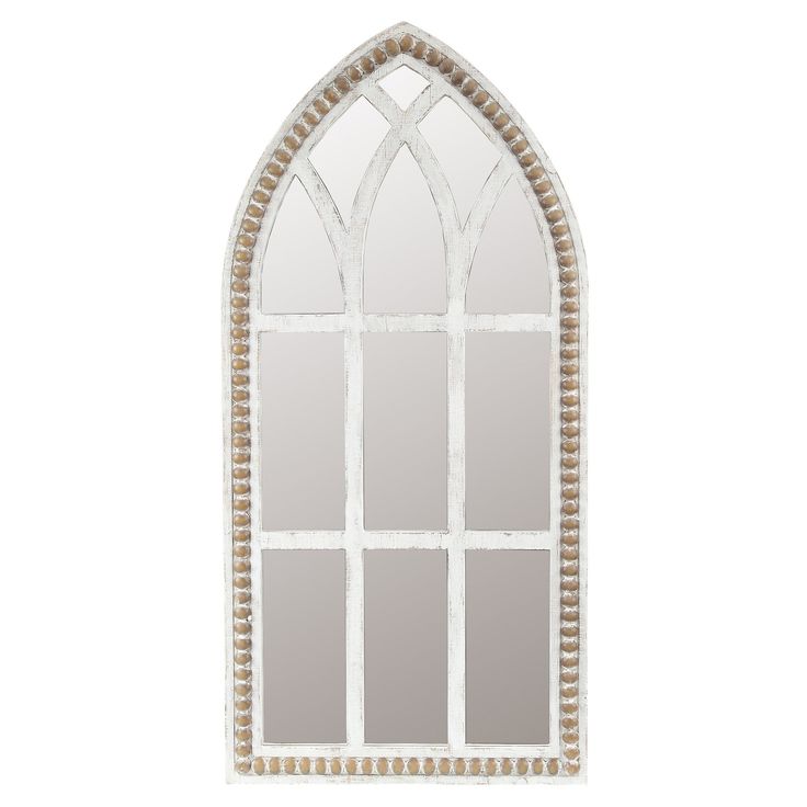 an arched window with beaded trim on the side and white frame, is shown