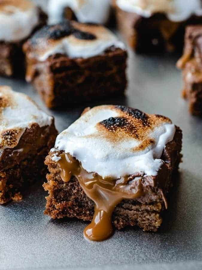 some brownies with marshmallows on top of them and drizzled with icing