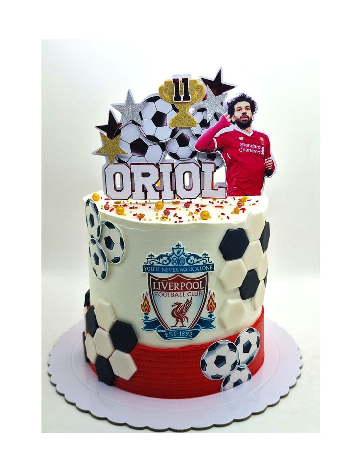 a soccer themed birthday cake with a man on top