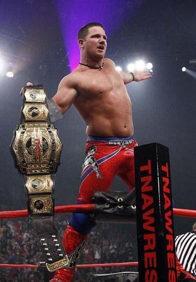 a man standing on top of a wrestling ring