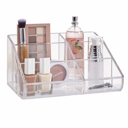 a clear acrylic container with various cosmetics and makeup products in the bottom section