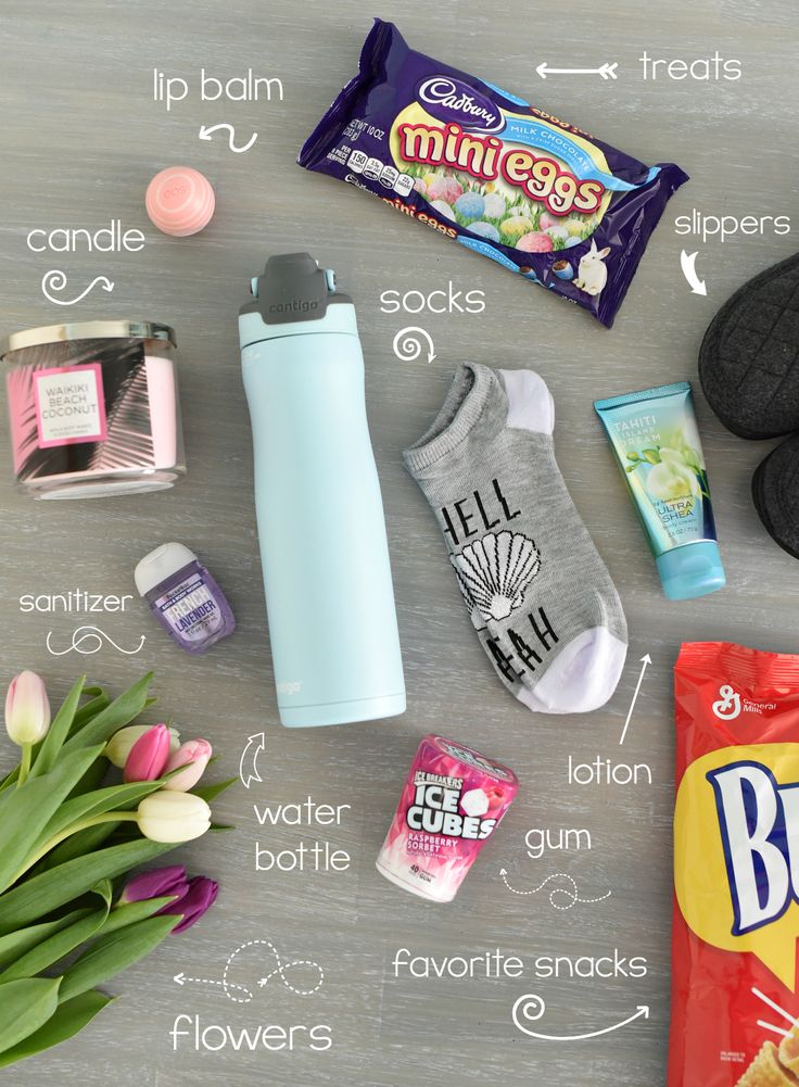 the contents of an ice cream bar laid out on a table with flowers and candy