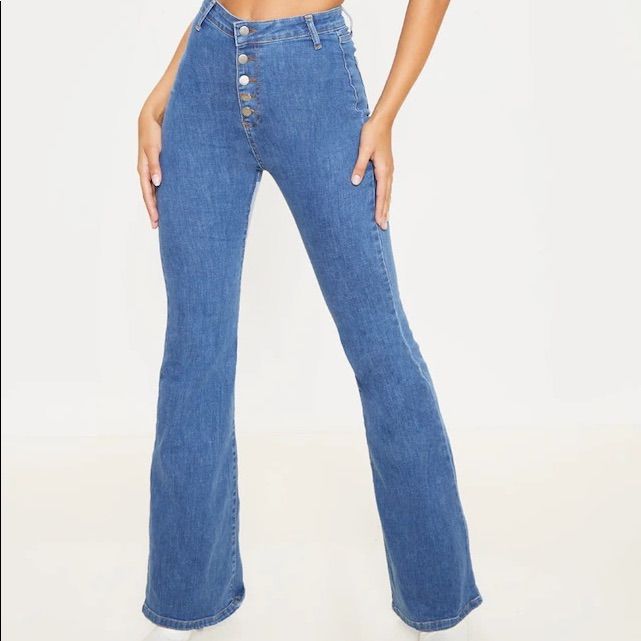 These Jeans Are Sure To Give Your Look A Vintage Vibe. Featuring A Mid Wash Denim Material With A High Waisted Fit, Button-Down Design And Flared Leg, Team With A Crop Top And Heeled Boots For A Look We Are Loving. Length Approx 86.5cm/34" (Based On A Sample Size Uk 8) Model Wears Size Uk 8/ Eu 36/ Aus 8/ Us 4 Model Height - 5ft 9" Blue Stretch Bottoms With Button Zip Fly, Stretch Blue Bottoms With Button Zip Fly, Fitted Denim Blue Bottoms With Button Closure, Stretch Denim Bottoms With Buttons, Trendy Denim Blue Button-up Bottoms, Trendy Non-stretch Button-up Jeans, Trendy Button-up Denim Blue Bottoms, Trendy Button-up Denim Bottoms, Fitted Medium Wash Pants With Button Closure