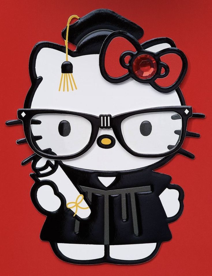 a paper cut out of a hello kitty wearing glasses and a graduation cap with a tassel