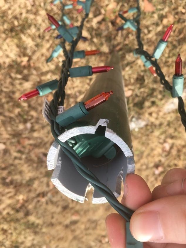 a hand is holding an electrical wire that has been wrapped in wires and plugged into the ground