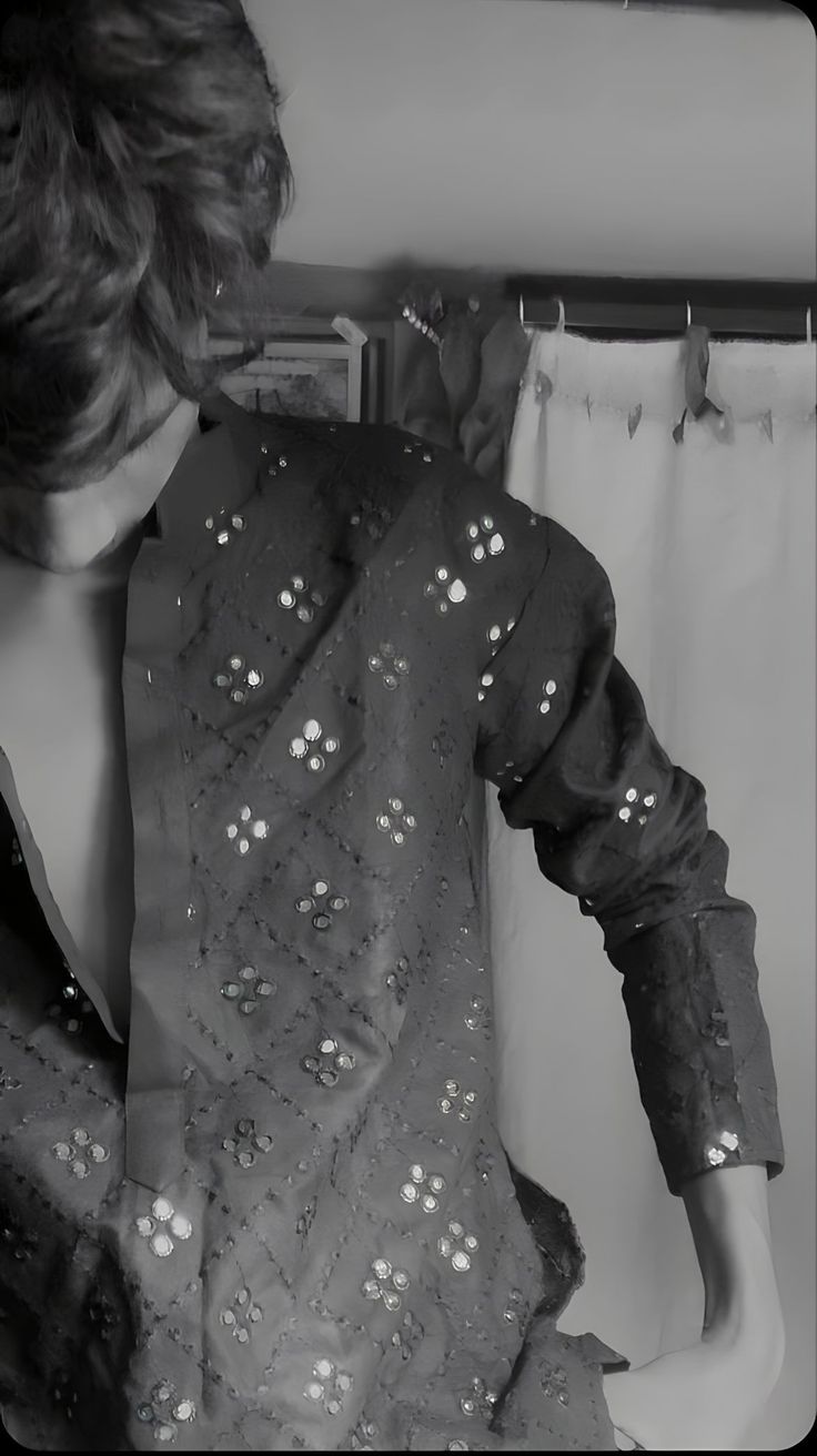 black and white photograph of a woman's shirt with sequins on it