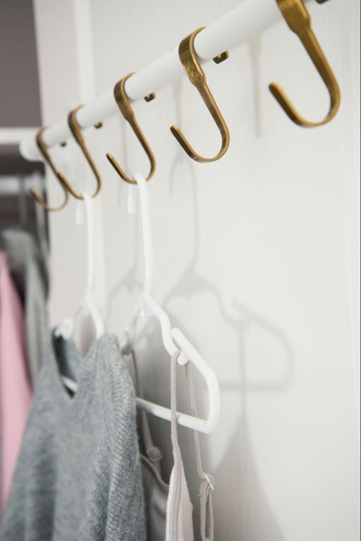 several clothes hangers are hanging on the wall