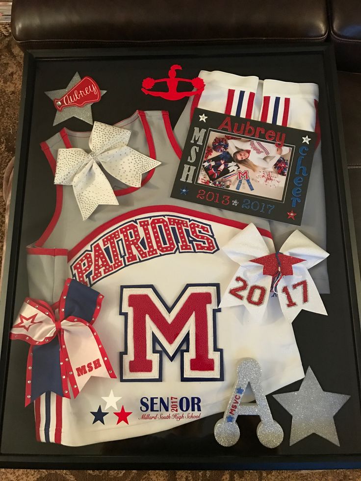 the sports team's uniform is displayed in a shadow box with ribbons and bows