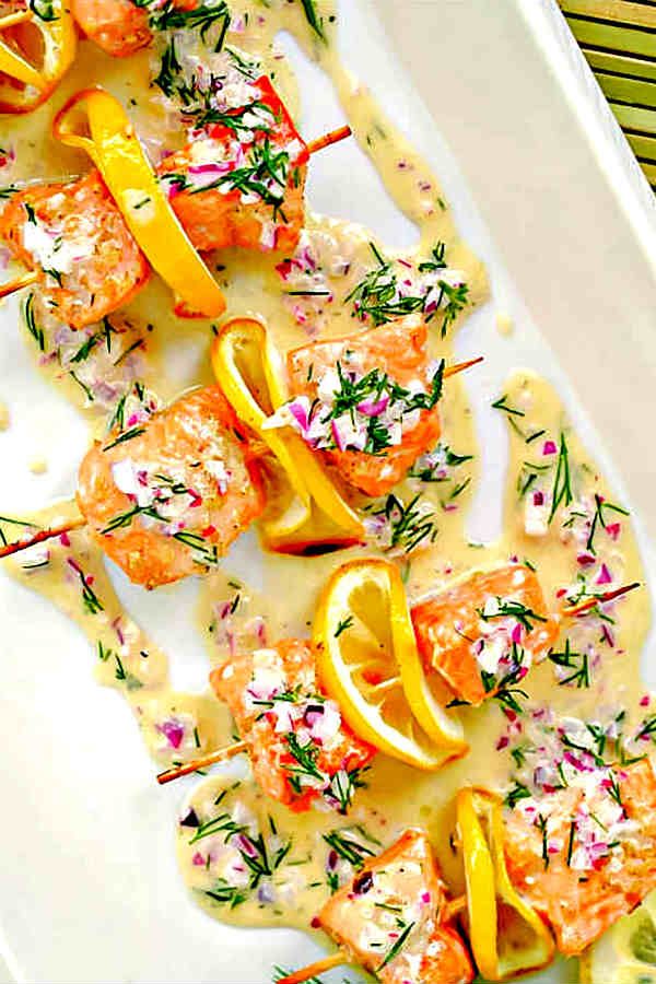 a white plate topped with shrimp and orange slices