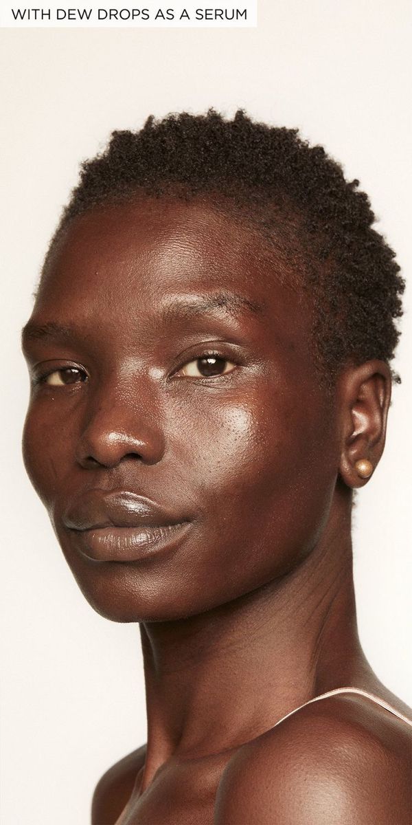 a woman with dark skin and brown eyes