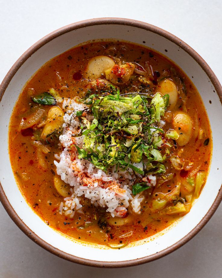 a white bowl filled with soup and vegetables