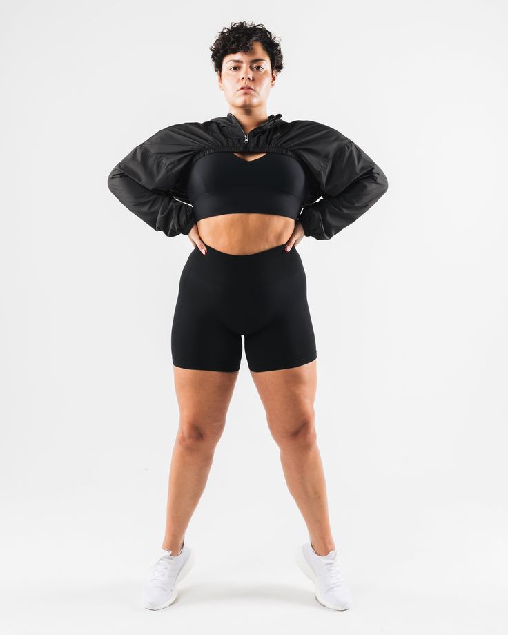 HIGHLIGHTS. Woven fabric Long sleeve Alphalete wolf logo FIT SUGGESTION. This item runs true to Alphalete's standard size... Jessica is 5’3”/160cm, wearing a size XS with a 30”/77.5cm bust. Sabrina is 6’0”/183cm, wearing a size XL. with 44.5"/113cm bust. MATERIALS AND WASHING DIRECTIONS. 100% Polyester. We recommend washing inside-out on a cold setting. Hang to dry DESCRIPTION With a silky smooth woven fabric, this jacket is perfect for wearing to and from the gym or during a cold outdoor workou Stretch Long Sleeve Windbreaker, High Stretch Nylon Outerwear For Sports, Fitted Black Windbreaker For Sports, Sports Nylon Outerwear With High Stretch, High Stretch Nylon Sports Outerwear, Black Fitted Nylon Track Jacket, Black Fitted Windbreaker For Sports, Fitted Functional Black Windbreaker, Sporty Fitted Black Windbreaker