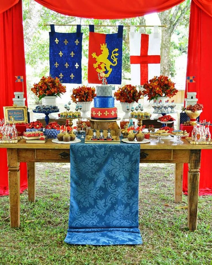 an image of a table with food on it and flags hanging from the ceiling in the background