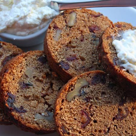 four pieces of bread on a plate with whipped cream in the middle and other food items