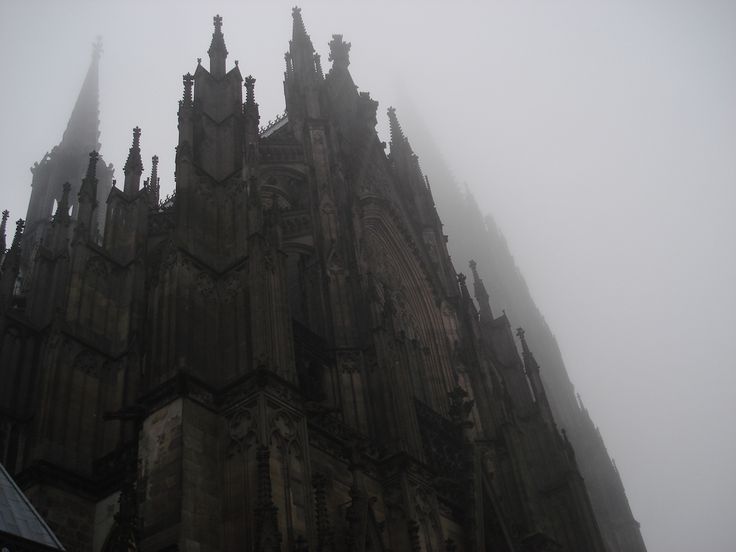 an image of a very tall building in the fog