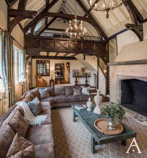 a large living room with couches and a fireplace