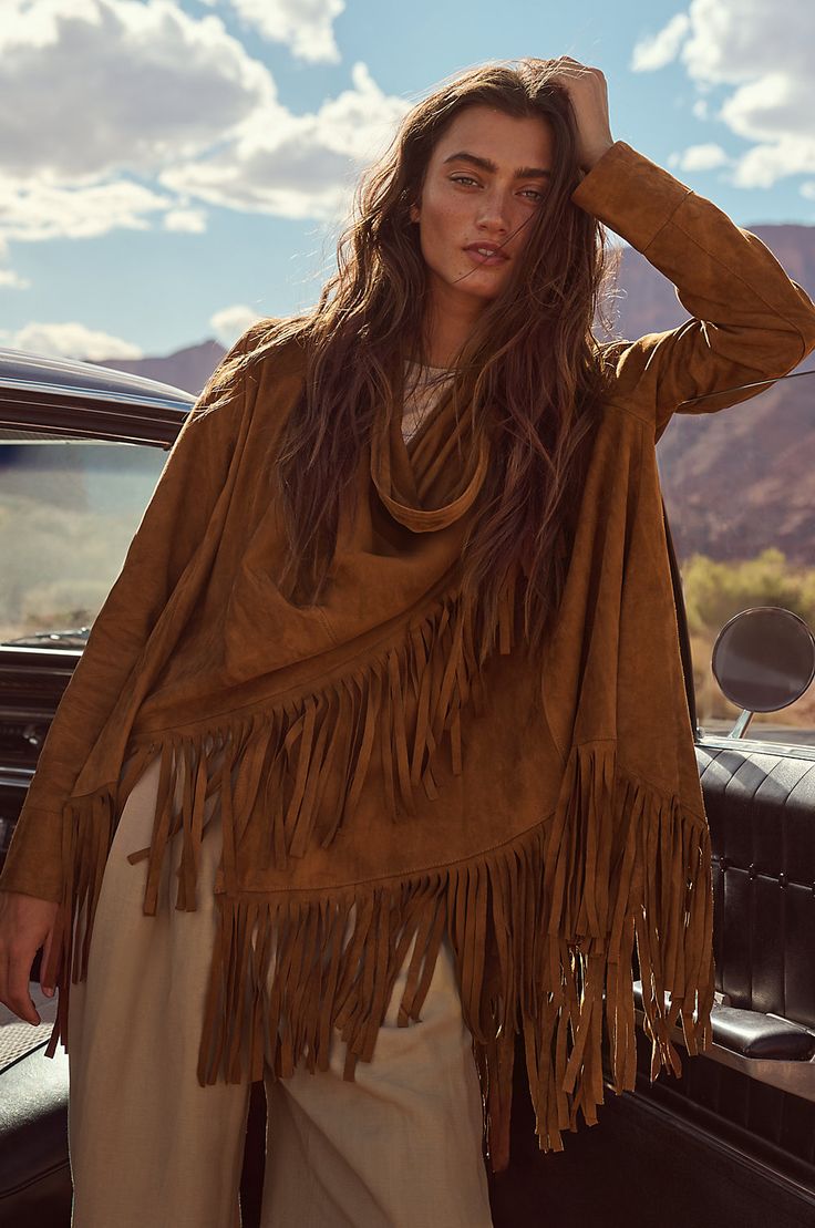 Bold and beautiful, the Trisha wrap jacket boasts 7" of fringe along its hem for movement and western-inspired style. Crafted from soft, supple goatskin suede leather, it can be worn two ways, both equally stunning: open, with the sides cascading down; or wrapped, with one side secured at the shoulder with a corozo button closure. Either way, you'll be the picture of rustic elegance. Featuring lined sleeves for comfortable wear. Wrap is 31 3/4" long plus 7" of fringe along hem. Leather Tassel Outerwear For Fall, Fall Leather Tassel Outerwear, Winter Leather Tassel Outerwear, Winter Leather Outerwear With Tassels, Rodeo Outerwear With Tassels, Bohemian Long Sleeve Leather Jacket For Fall, Bohemian Long-sleeve Leather Jacket For Fall, Chic Fringe Outerwear For Festivals, Chic Festival Outerwear With Fringe