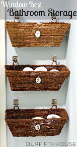 three baskets are hanging on the wall