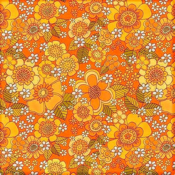 an orange and yellow flowered background with lots of small white flowers on the bottom