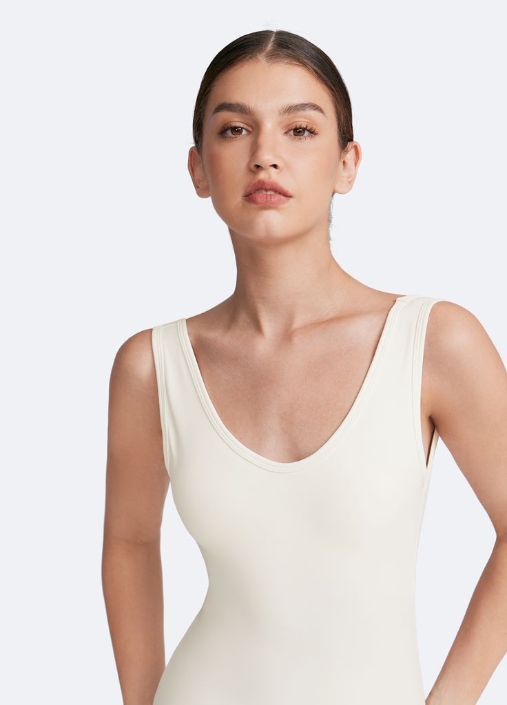 Sculpt and smooth with our Waist-Contouring Bodysuit. Designed to enhance your natural shape, this bodysuit provides gentle compression for a flattering fit in standard and plus size options. Whether layered or worn on its own, it’s the perfect mix of style and support. Fitted V-neck Shapewear For Summer, Chic Seamless Bodysuit For Loungewear, Chic Second-skin Seamless Leotard, Elegant Summer Leotard With Smoothing Detail, Elegant Summer Leotard With Smoothing Feature, Smoothing Bodysuit With Minimal Stretch For Loungewear, Elegant One-piece Bodysuit With Minimal Stretch, Classic Stretch Seamless Bodysuit, Classic Seamless Stretch Bodysuit