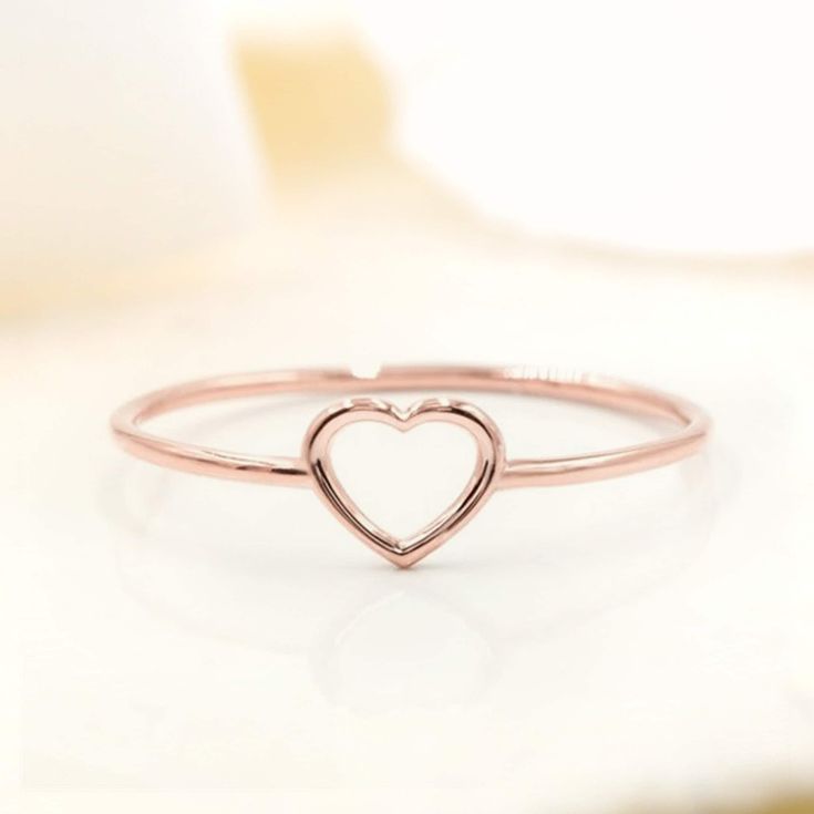 Show your love for her with our shaped dainty ring. It features a light dainty band, and a cute heart shape on top to always remind her of your love. Stack great with our other rings as well! Available in your choice of: Solid 14k & 18K Golds, Silver, or Gold Plated over Silver Base 1.2mm-1.4mm average width Dainty Heart-shaped Midi Promise Rings, Simple Heart Promise Ring For Valentine's Day, Simple Heart-shaped Midi Promise Ring, Delicate Stackable Promise Rings For Valentine's Day, Stackable Rose Gold Heart Ring For Valentine's Day, Minimalist Stackable Rings For Promise On Valentine's Day, Rose Gold Stackable Heart Ring For Valentine's Day, Minimalist Stackable Rings For Valentine's Day Promise, Delicate Rose Gold Heart Ring For Valentine's Day