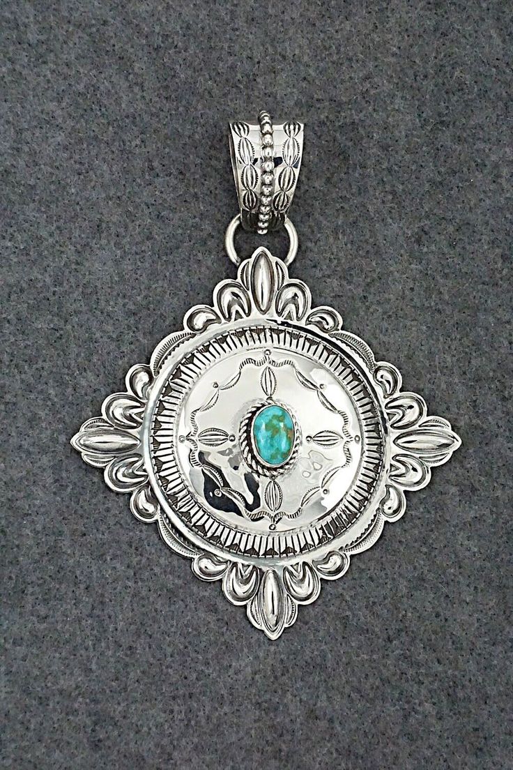 This stunning Sonoran Gold turquoise and sterling silver pendant was made by Navajo silversmith Roland Dixon. The back is signed Roland Dixon and stamped sterling.Length: 5 1/2"Width: 4 1/8"Free shipping on all orders! We ship with USPS and always include tracking. All orders ship within a day of payment.Returns are accepted up to 30 days after you receive your order. Just send us a message. Our shop offers cash back or store credit. The item must be returned in new condition. Southwestern Engraved Turquoise Necklace In Sterling Silver, Traditional Silver Turquoise Concho Necklace, Traditional Silver Turquoise Necklace With Concho, Southwestern Sterling Silver Turquoise Concho Necklace, Silver Southwestern Turquoise Necklace With Round Pendant, Southwestern Silver Turquoise Necklace With Round Pendant, Sterling Silver Turquoise Necklace With Concho, Engraved Silver Southwestern Turquoise Necklace, Engraved Silver Turquoise Necklace In Southwestern Style