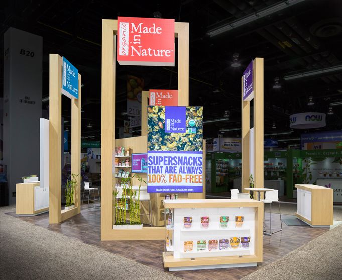 an exhibit booth at a trade show with signs on the walls and displays in wooden frames