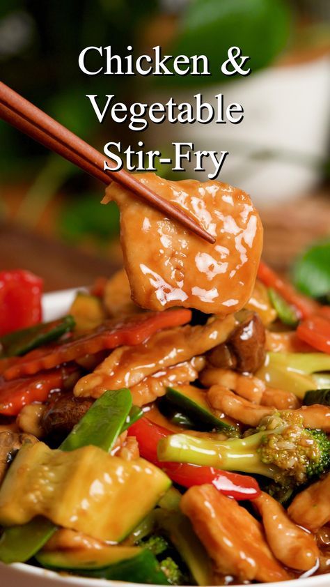 chicken and vegetable stir fry with chopsticks in a bowl