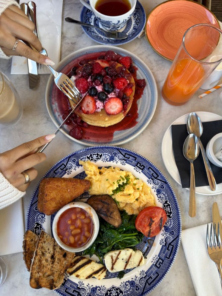 a table topped with plates of food and drinks