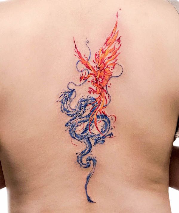 the back of a woman's upper body with a dragon tattoo on her left side