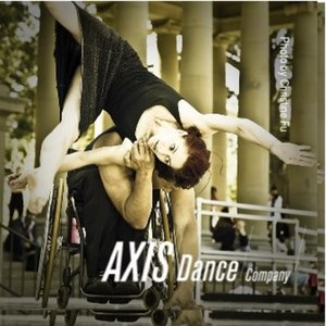 a man in a wheel chair doing a handstand on his head with the words axs dance company above him