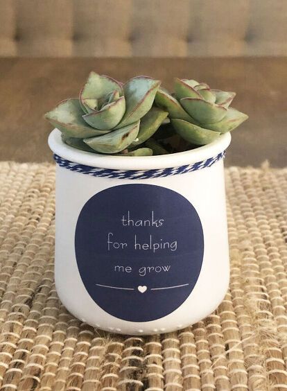 a potted plant sitting on top of a woven place mat with a chalkboard saying thanks for helping me grow