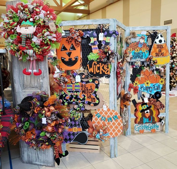 a display in a store filled with lots of halloween decorations and wreaths on the doors