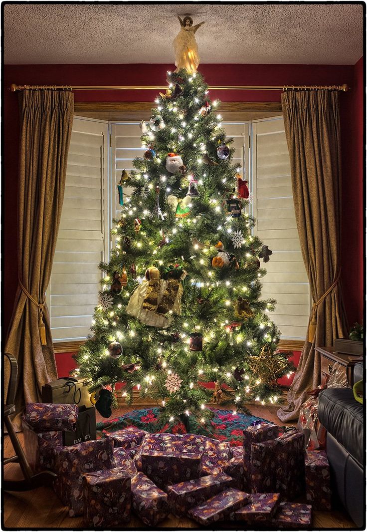 a decorated christmas tree with presents under it