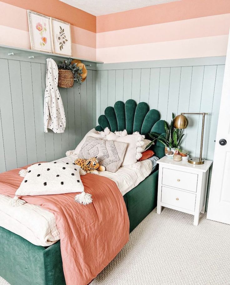 a bedroom with pink, green and white walls