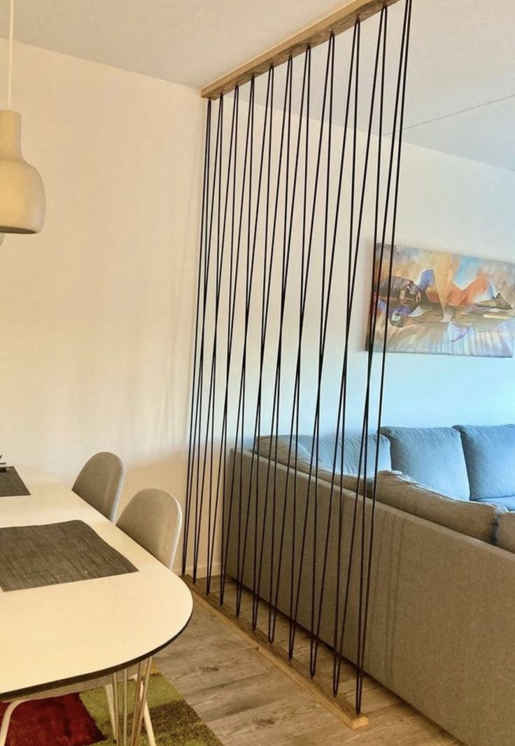 a dining room table with chairs and a couch in front of a sliding glass door