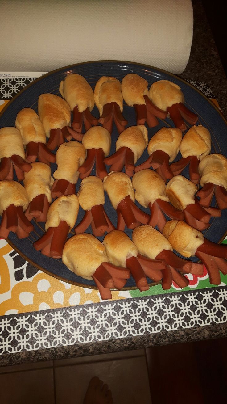 a plate full of pigs in a blanket on top of a table