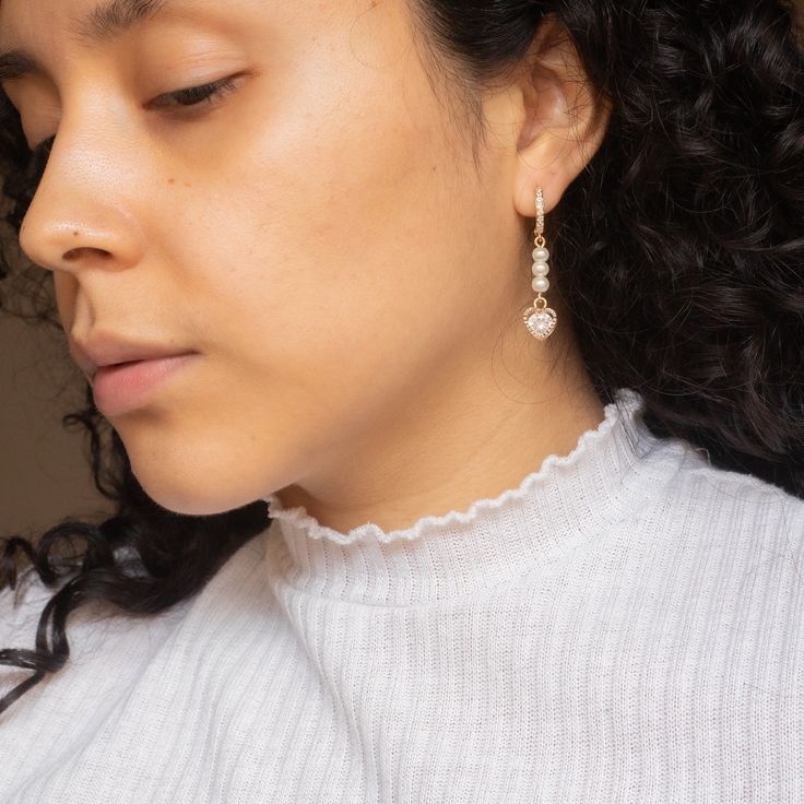 Handcrafted out of wire, faux pearls and cubic zirconia heart shaped charms! And also modeled by me :-) #handmadeearrings #daintyearrings #earringsociety #minimalistearrings #earringsoftheday #cutejewelry #pearlearrings #handmadebusiness #luxuryearrings #studdedearrings #goldjewelry #charmearrings #trendyearrings #springjewelry #modernjewelry #fashionfinds #handmadefashion #jewelryinspo #jewelryinspiration Elegant Dangle Heart Earrings For Wedding, Heart-shaped Crystal Earrings For Wedding, Heart-shaped Cubic Zirconia Crystal Earrings For Wedding, Cubic Zirconia Heart Earrings For Wedding, Wedding Heart Drop Earrings Single Piece, Elegant White Cubic Zirconia Heart Earrings, Heart-shaped Earrings With Sparkling Stones For Wedding, Silver Heart Earrings With Pearl Drop, Heart-shaped Crystal Earrings With Cubic Zirconia