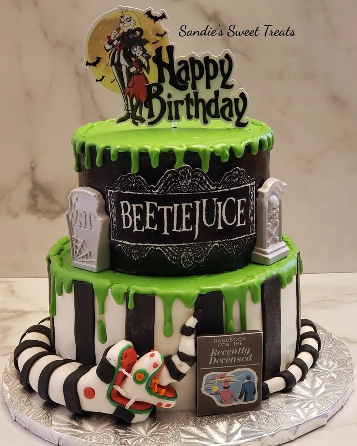 a birthday cake decorated with green and black icing