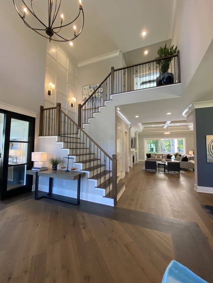 a living room filled with furniture and a staircase