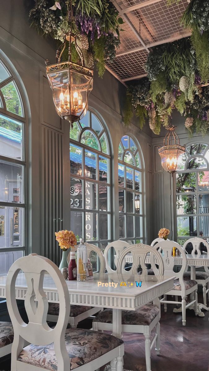 the dining room is decorated with hanging plants