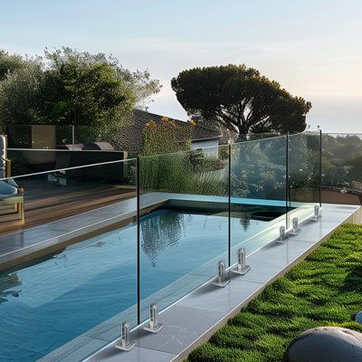 an outdoor swimming pool with grass on the ground