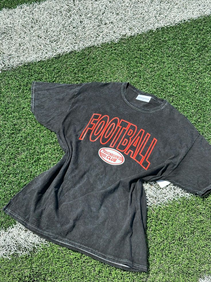 Get ready to make a statement with our footbalk touchdown club tee, featuring a trendy retro graphic that reads “Football Touchdown Club.” This chic, elegant, boujee, and trendy preppy design is perfect for showing off your love for the game. The unique acid-washed fabric adds a vintage flair, making it ideal for supporting your favorite college or professional football team and rocking at tailgate parties. Stay stylish and comfortable while cheering on your team with this must-have game day shirt. **Key features:**- Chic, elegant, boujee, trendy retro preppy design- Retro graphic with “Football Touchdown Club” lettering- Unique black acid-washed cotton blend fabric- Perfect for college and professional football games, and tailgate parties **Keywords:** Women's Black Acid Washed Shirt, Foo Sporty Graphic Print Top For Tailgating, Black Retro Top For Game Day, Game Day Logo Print T-shirt For Fall, Retro Tops With Graphic Print For Football Season, Retro Logo Print T-shirt For Game Day, Retro Graphic Print Top For Football Season, Retro Game Day T-shirt With Logo Print, Retro College T-shirt For Football Season, Relaxed Fit Game Day Graphic T-shirt