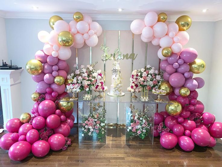 balloons and flowers are arranged in the shape of an arch