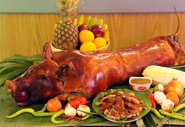 a large piece of meat sitting on top of a table next to fruit and vegetables